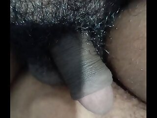 A well-endowed black stud with a hairy cock craves a handjob. He enlists a hot shemale to stroke his shaft, leading to a steamy, cum-filled climax in this homemade video.